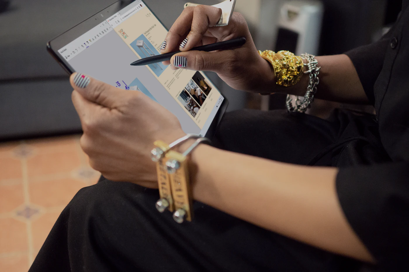 A designer marking up a page layout on a tablet with a stylus
